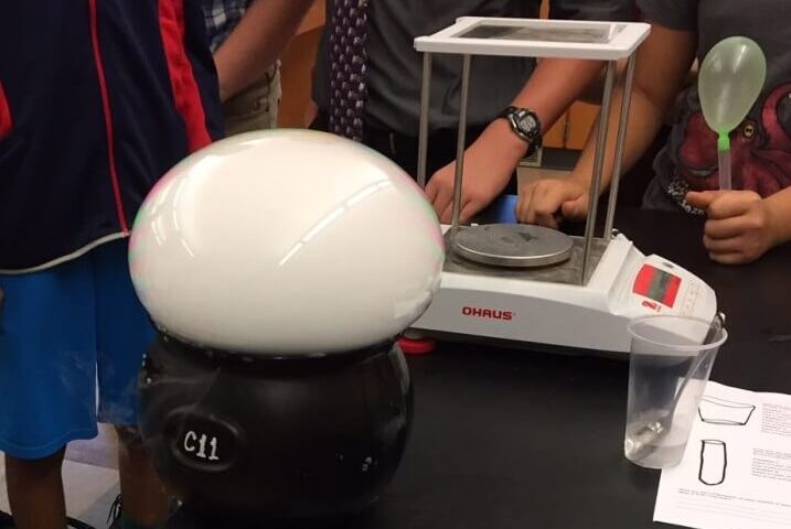 Students looking over scale.