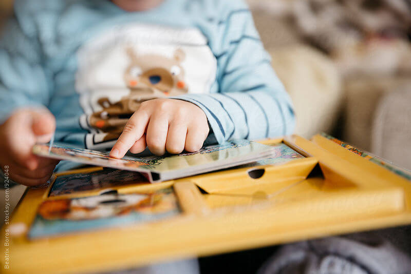Unrecognizable boy reading book
